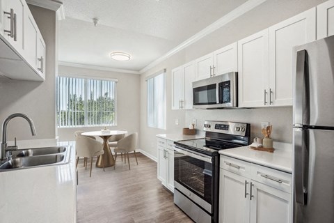 North Natomas, Sacramento, CA, Apartments with In-Unit Washer and Dryer - Granite Point Apartments - White Kitchen With Shaker Cabinets, Stainless Steel Appliances, and Quartz Countertops.