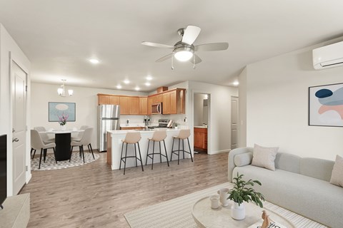 A well-lit, spacious living room with a dining area in the background.