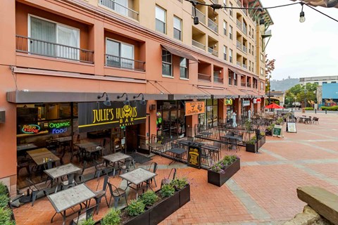 A restaurant named Jules Trumbo is located in a courtyard with tables and chairs.