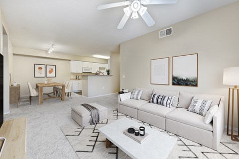 A living room with a white couch and a coffee table.
