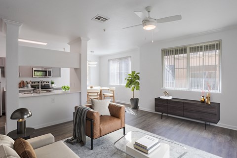 A modern living room with a brown leather couch and a glass coffee table.
