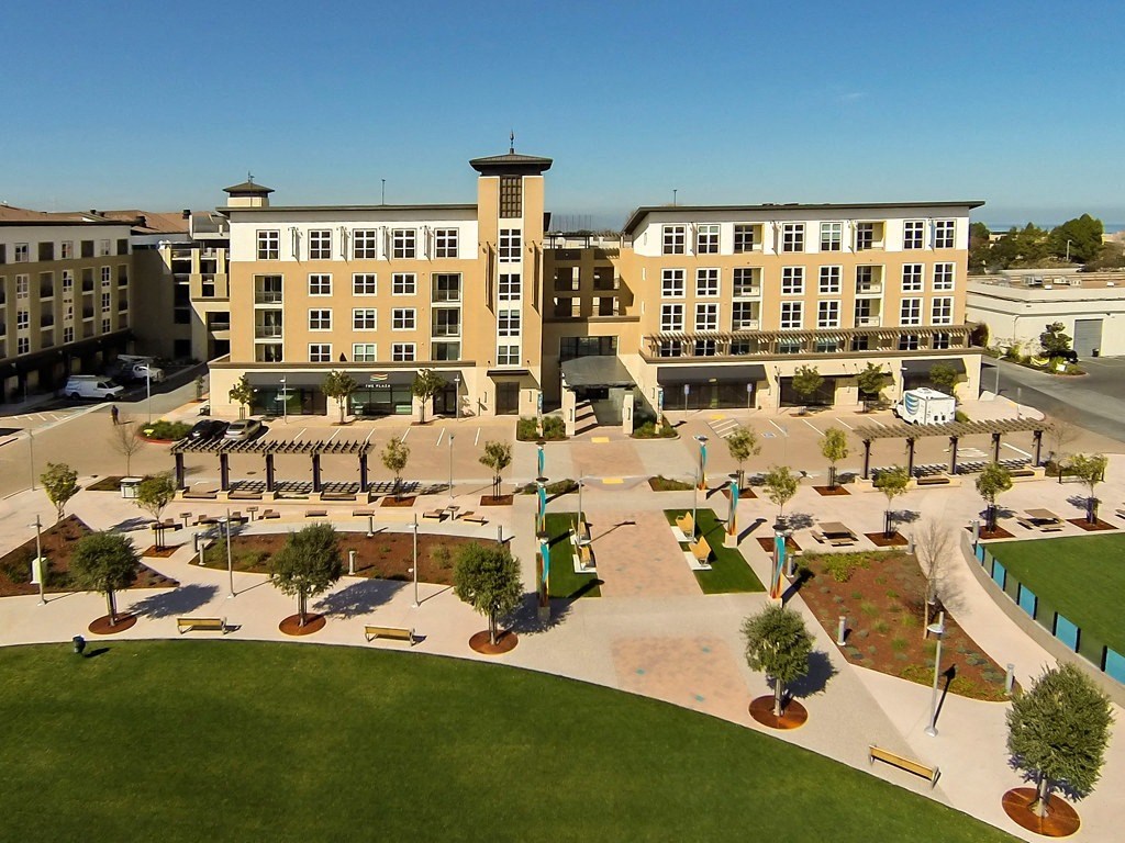 an aerial view of a parking lot in front of a building
