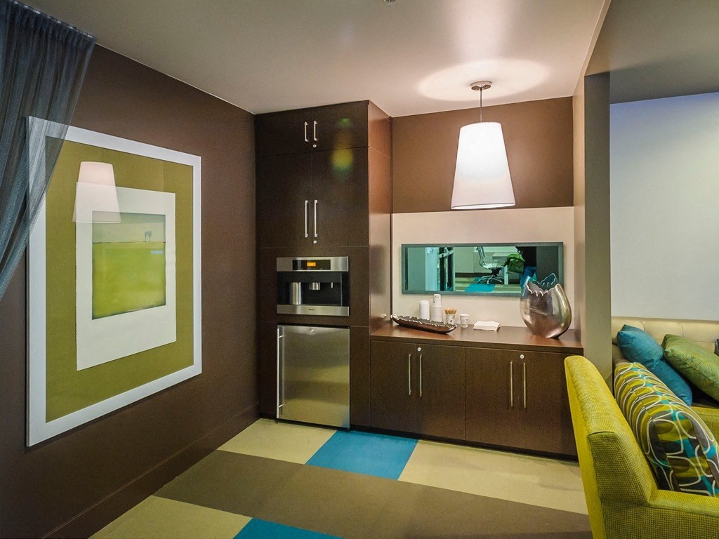 a kitchen and living room in a hotel room