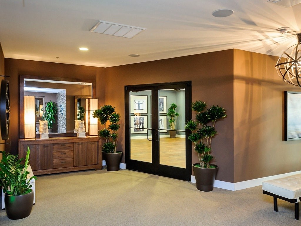 a lobby with a reception desk and glass doors