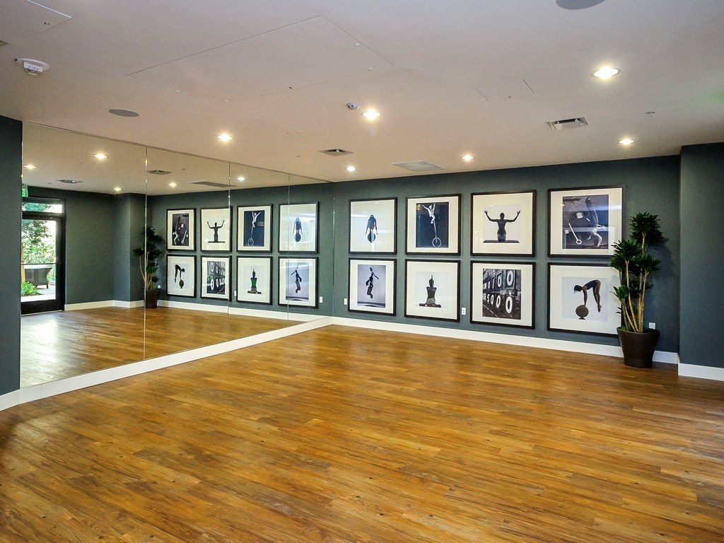 a large room with a wall of framed pictures on it