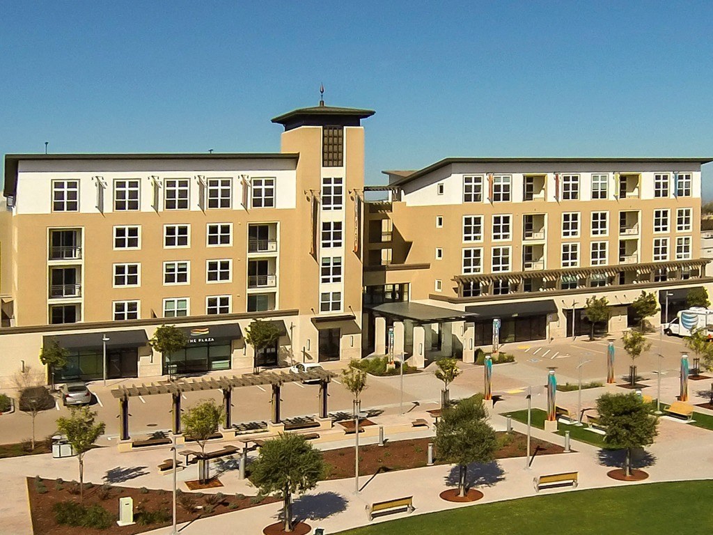 an aerial view of an apartment complex with a parking lot