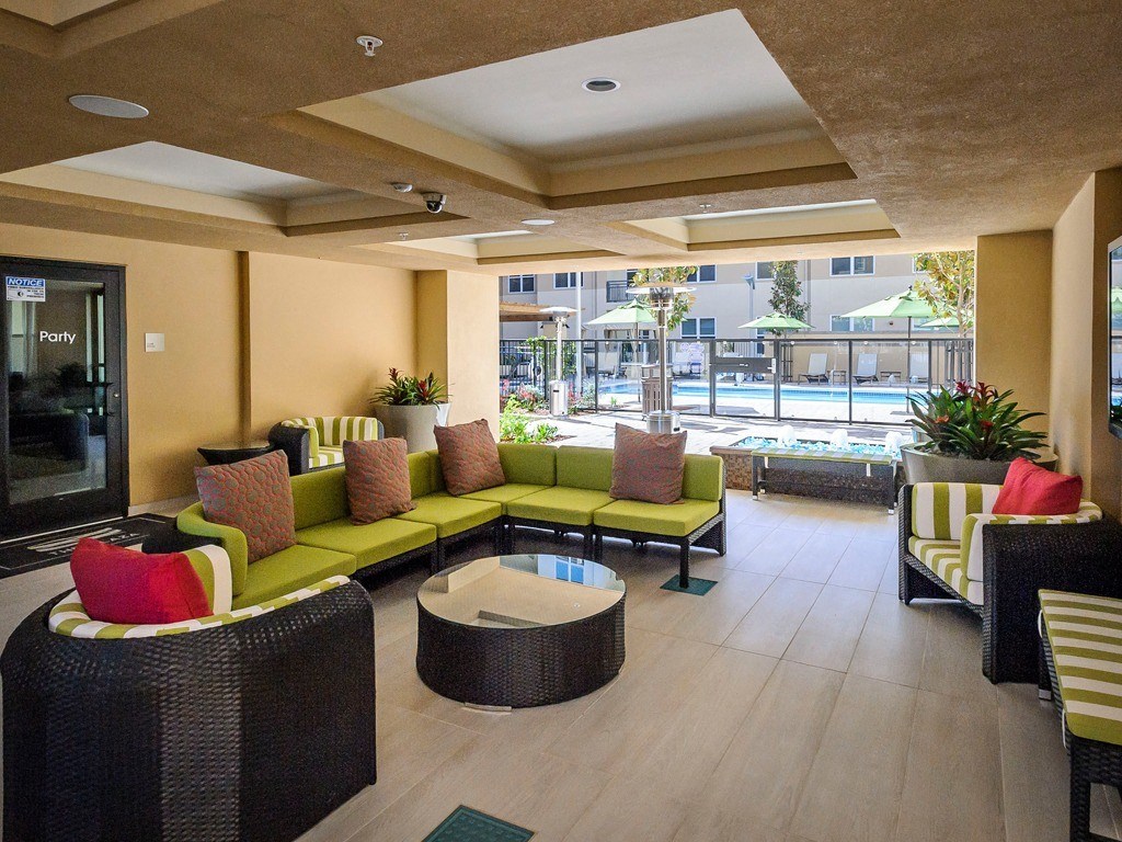 a lobby with couches and chairs and a pool