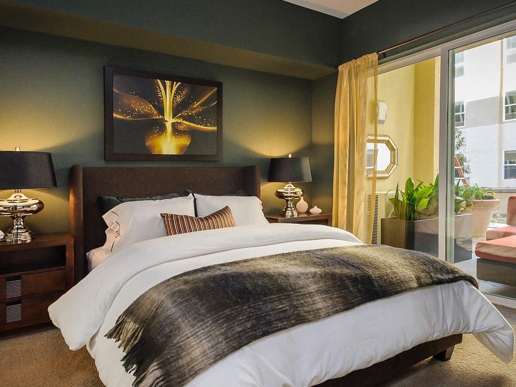 a bedroom with a bed and a large window