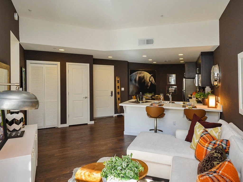 a living room with a couch and a kitchen