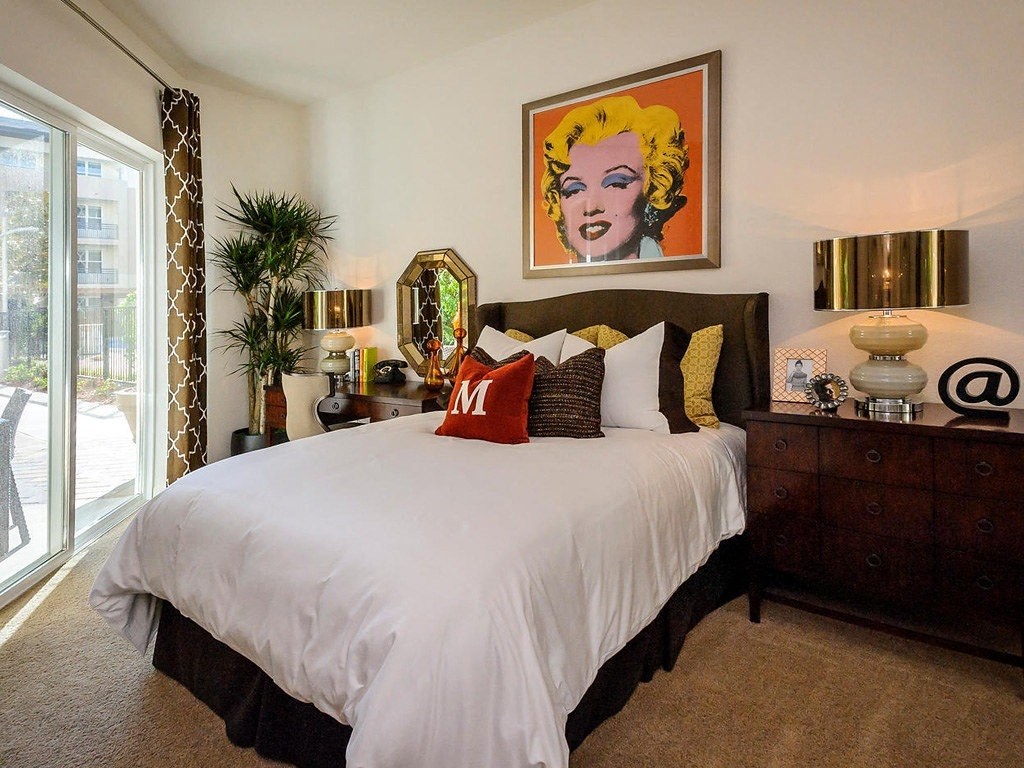 a bedroom with a bed and a painting on the wall