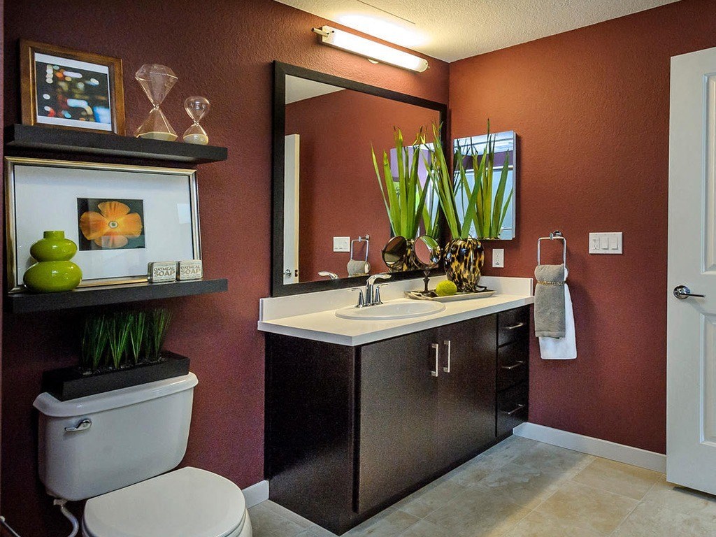 a bathroom with a toilet and a sink and a mirror