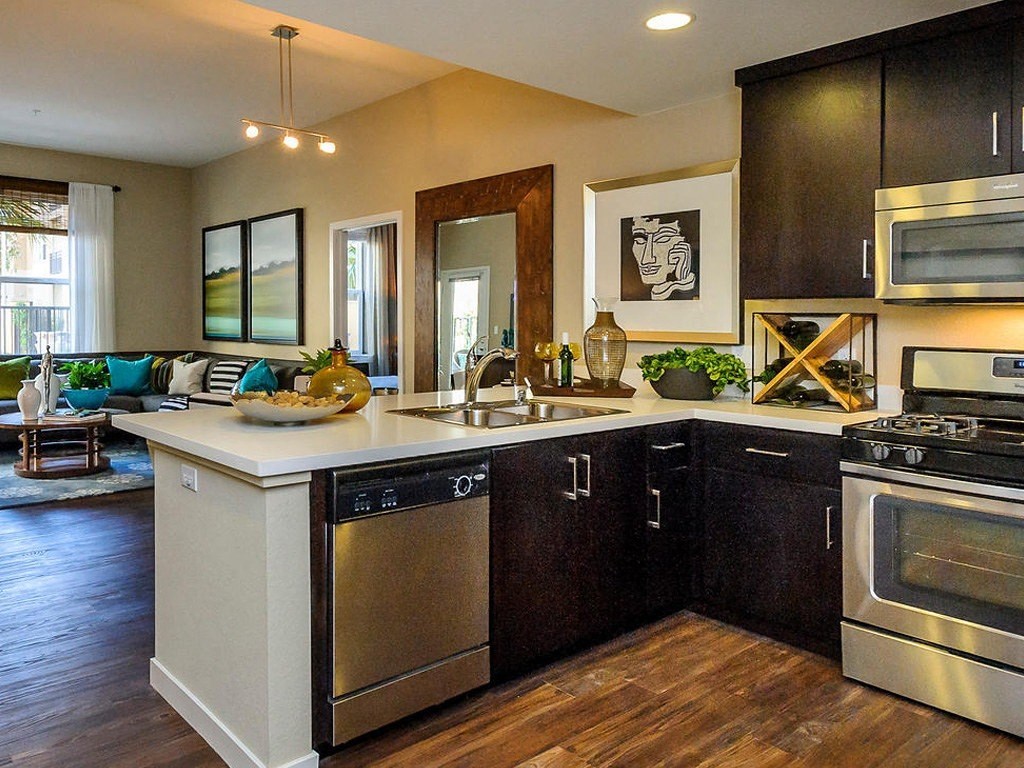 a kitchen with stainless steel appliances and a counter top
