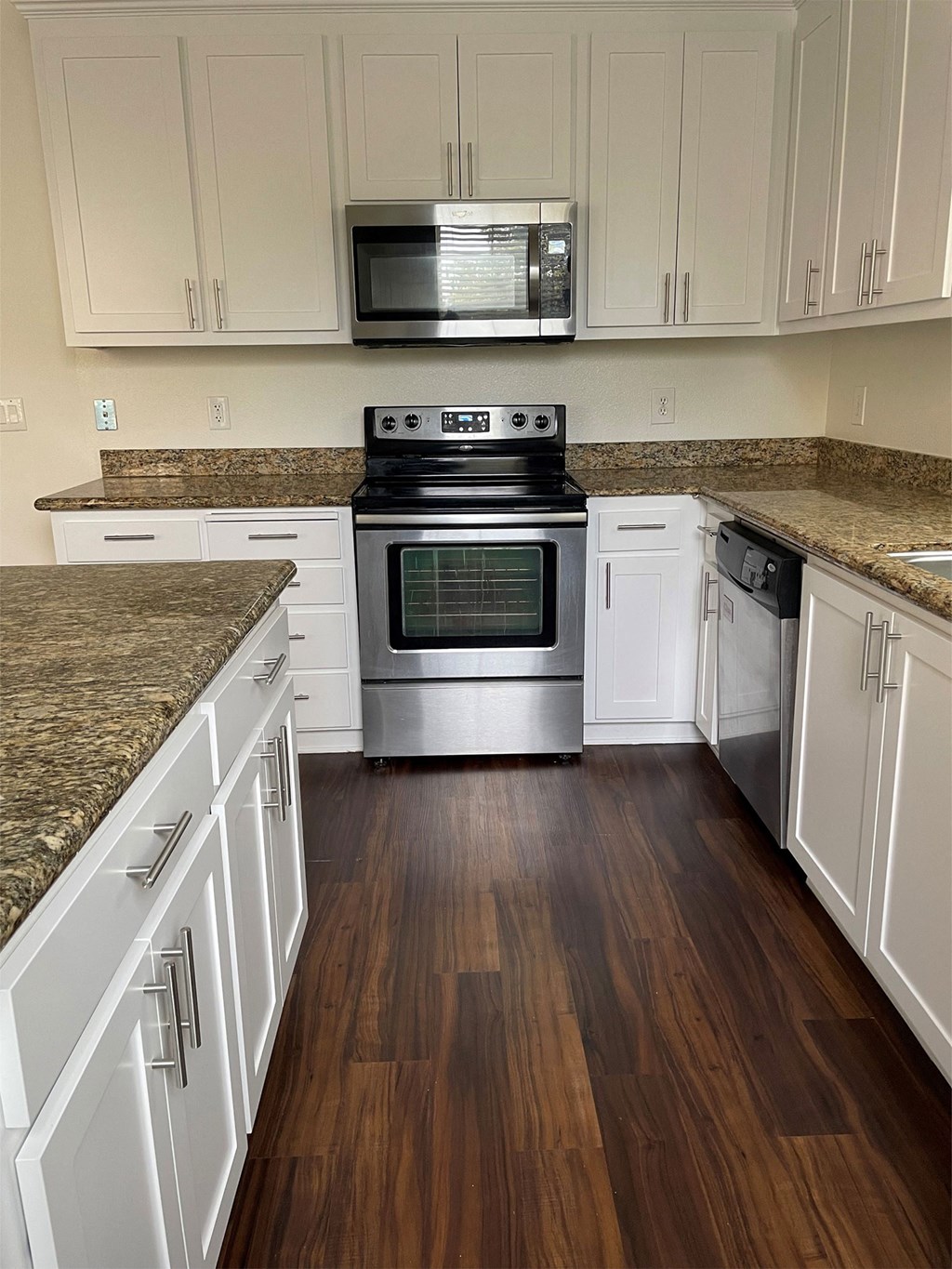 renovated kitchen with white cabinets