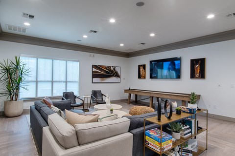 a living room with couches and chairs and a tv