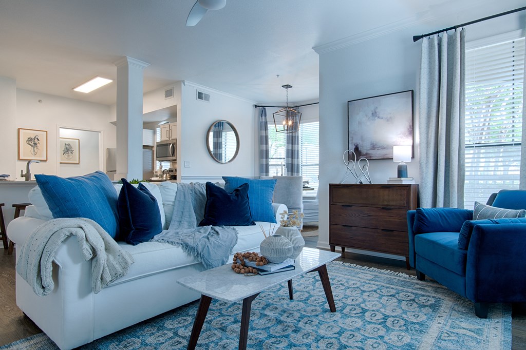 Livingroom with white couch and a blue chair