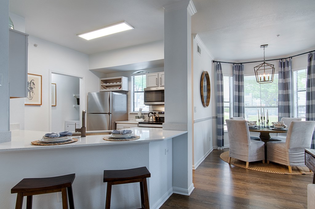 White Kitchen with counter tops, and chairs