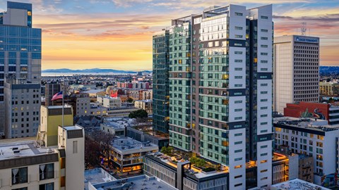 A cityscape with buildings and a sunset.