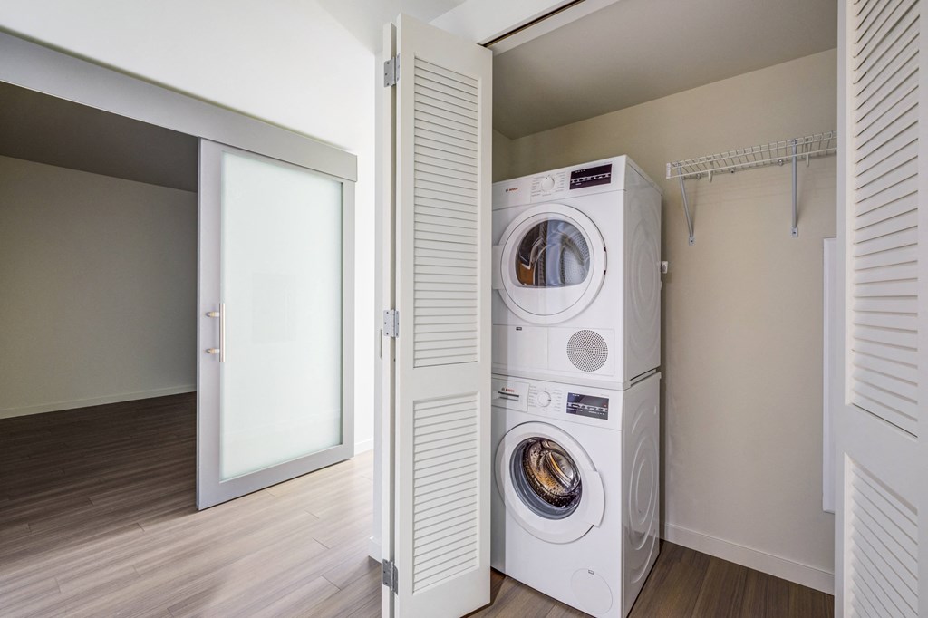 laundry closet with stacked washer and dryer