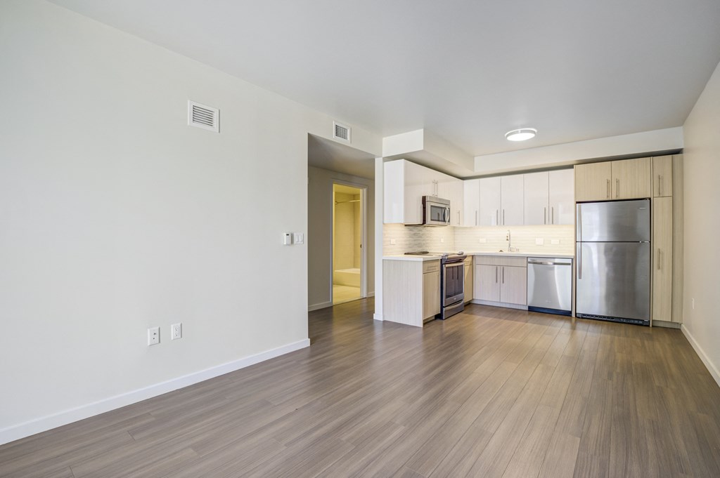 open floor plan with wood plank style flooring and stainless steel appliances
