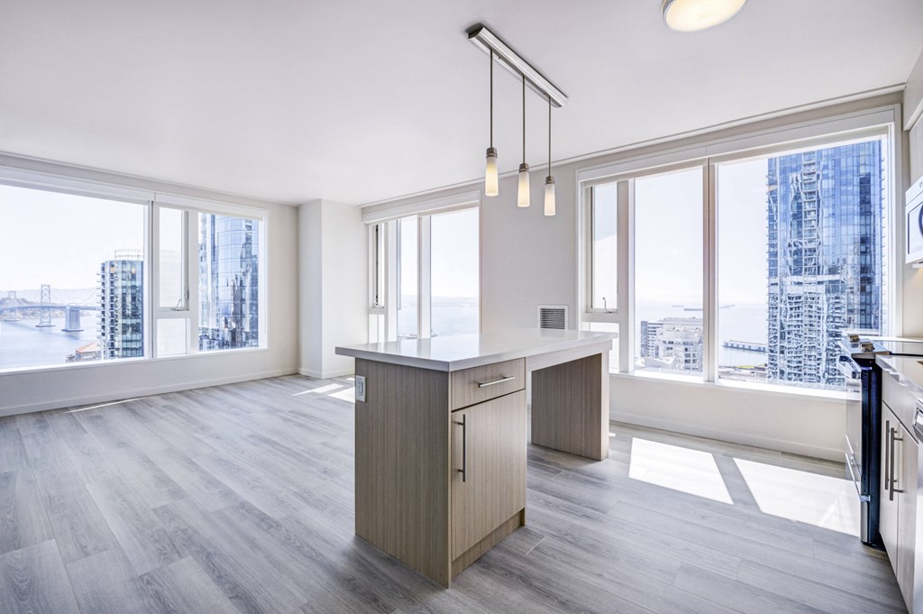 unfurnished floorplan with woodplank flooring and island