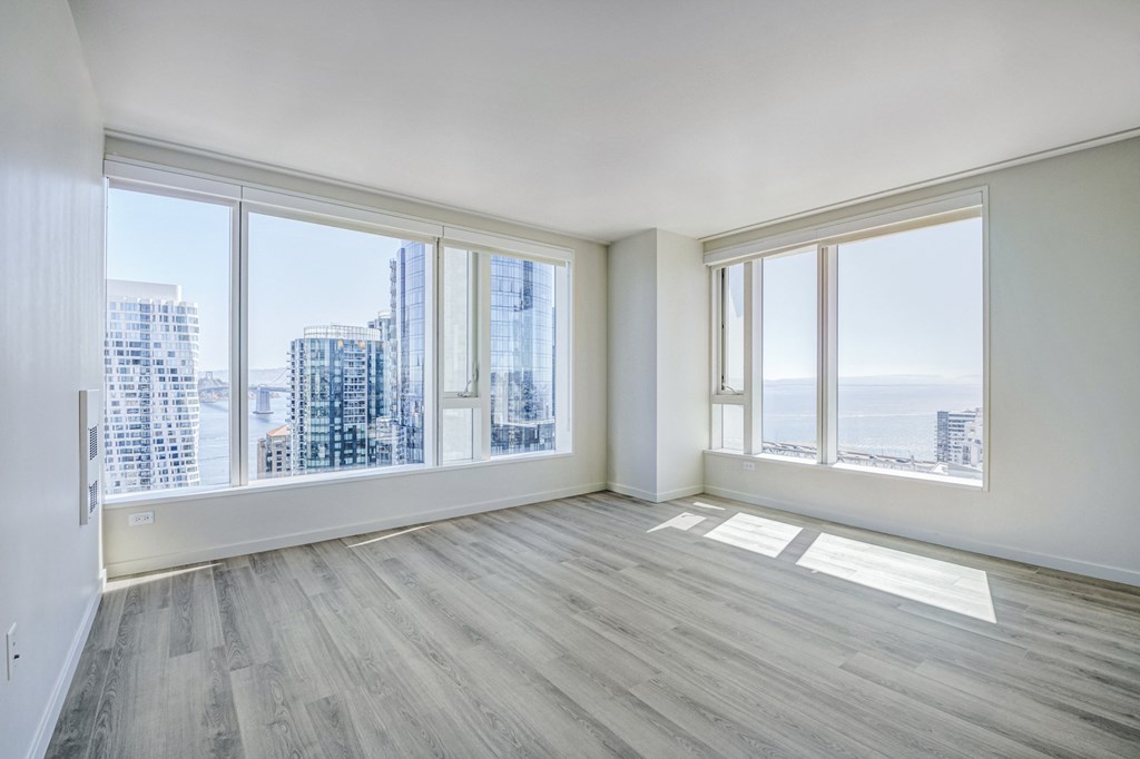 unfurnished floorplan with wide windows and woodplank style flooring