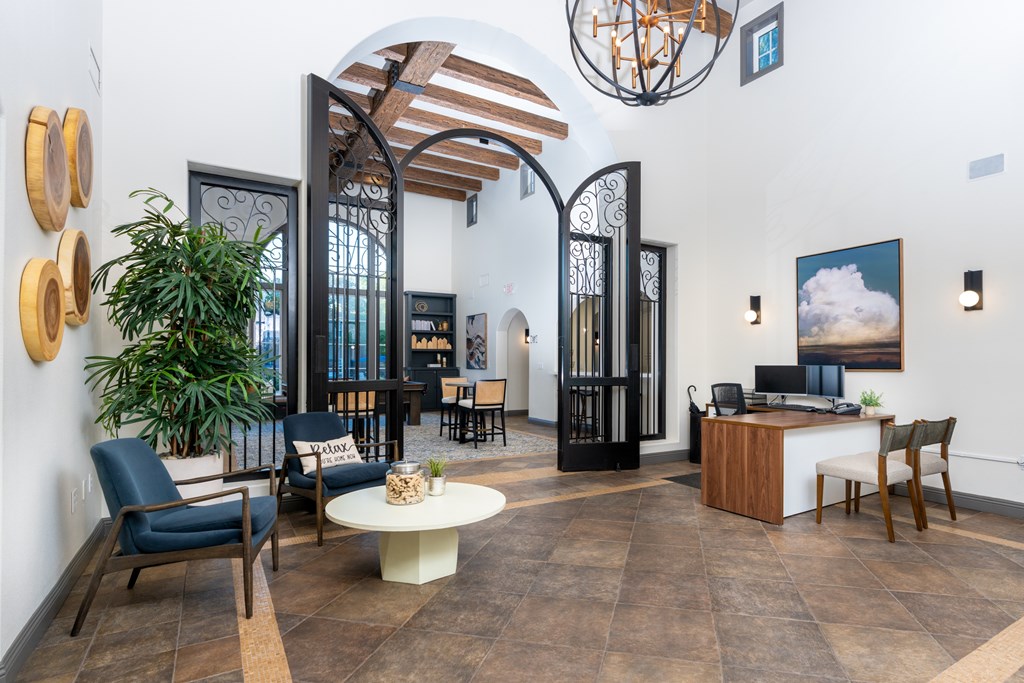 A room with a wooden floor and a white ceiling with a hanging light fixture.