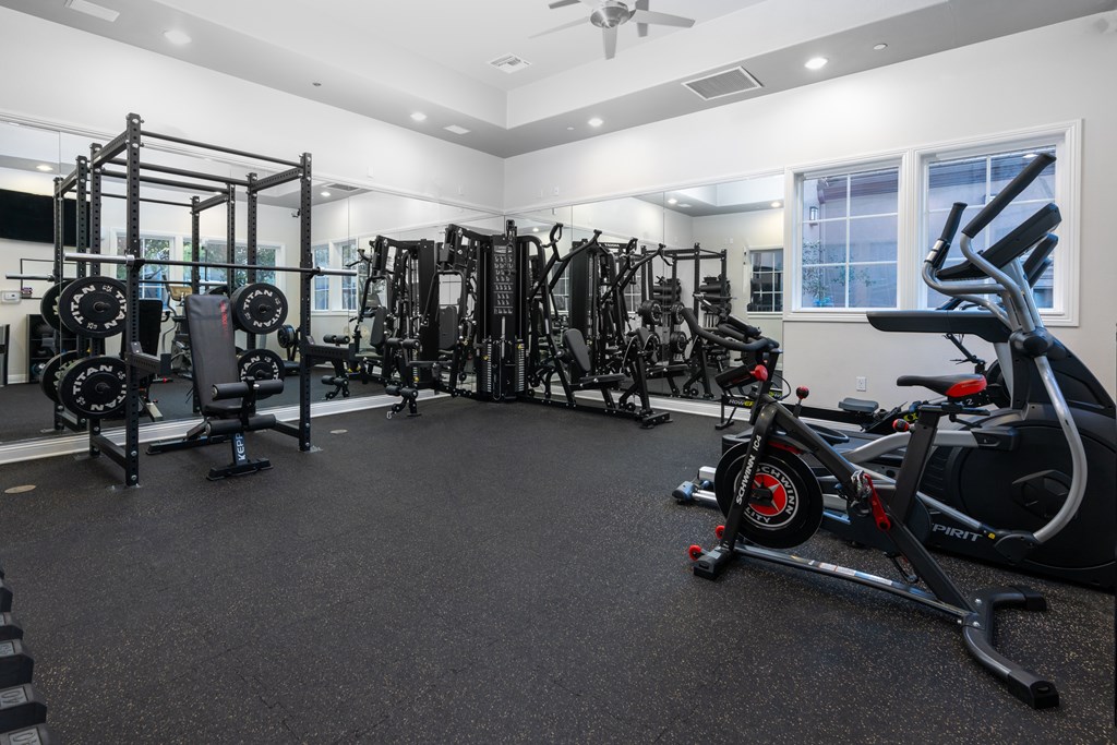 A spacious gym with a variety of equipment including treadmills, weights, and exercise machines.