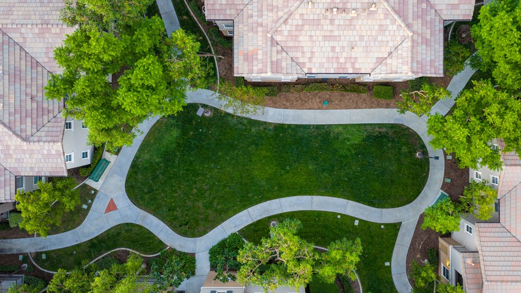 A park with a winding path and a red triangle marker.