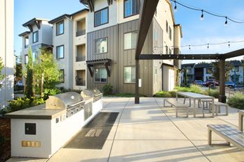 Outdoor barbecue grills with bench seating
