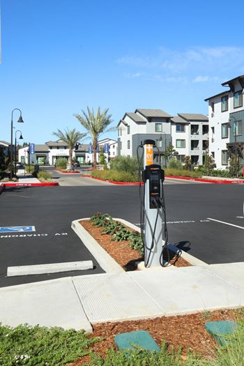 A parking lot with a charging station for electric vehicles.