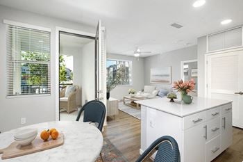 A kitchen with a table and chairs in front of a window.