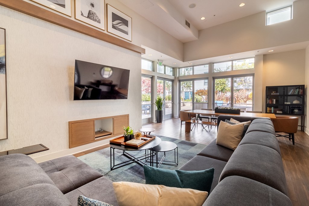 a living room with a large gray couch and a fireplace