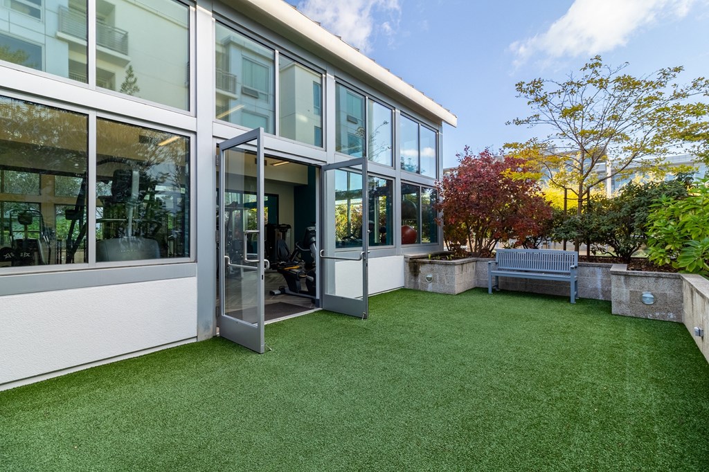 strata gym with outdoor green space and bench