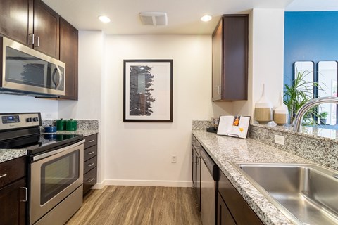 a kitchen with granite counter tops and stainless steel appliances