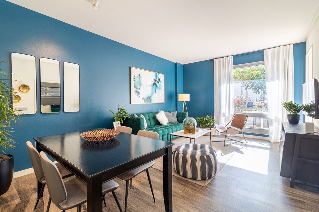 a living room with blue walls and a table and chairs at Strata at Mission Bay, San Francisco, 94158