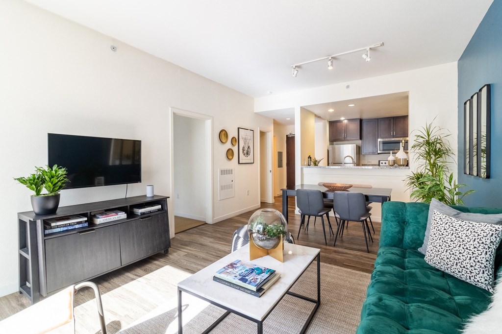 a living room with a green couch and a television