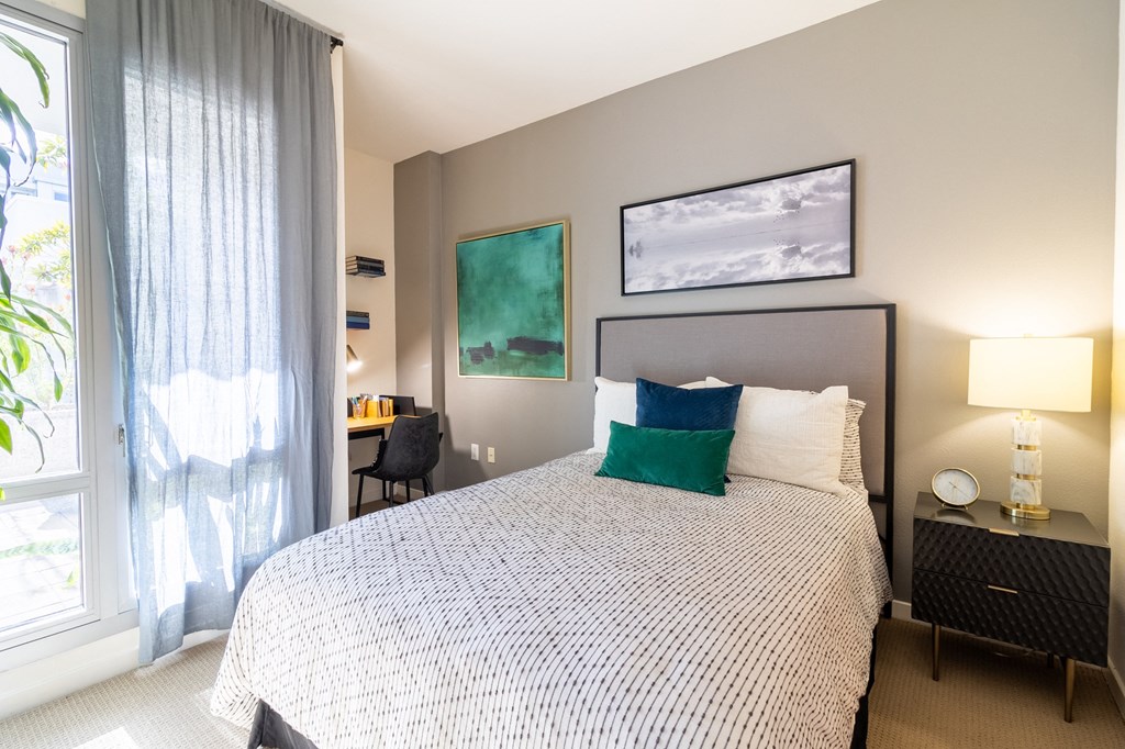 a bedroom with a large bed and a window a bedroom with a large bed and a window at Strata at Mission Bay, San Francisco, 94158