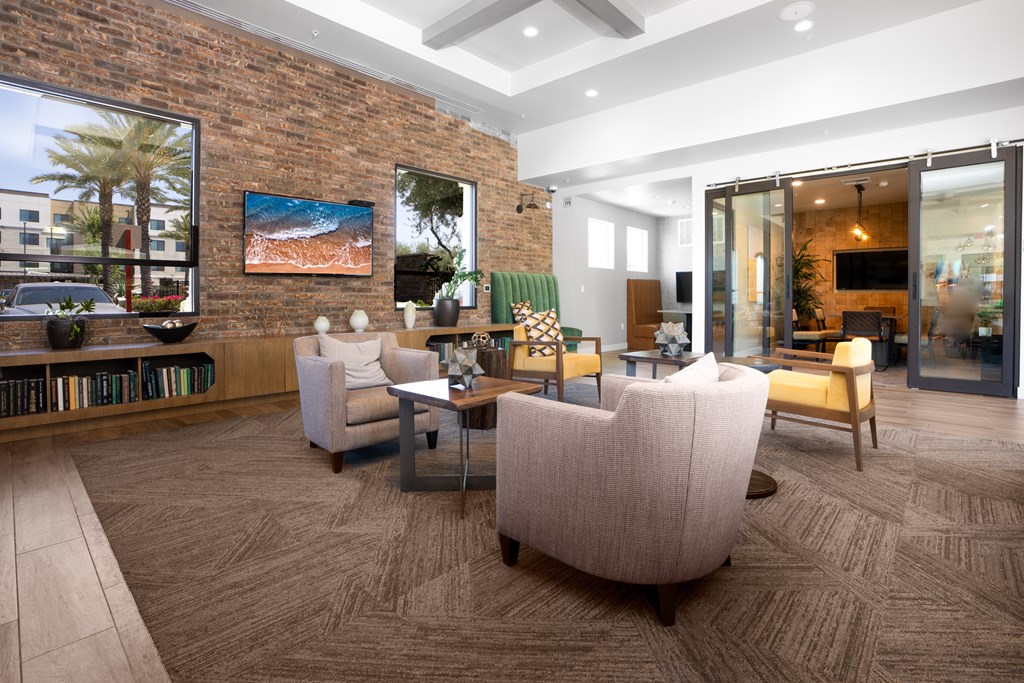 A living room with a brick wall and a large window.