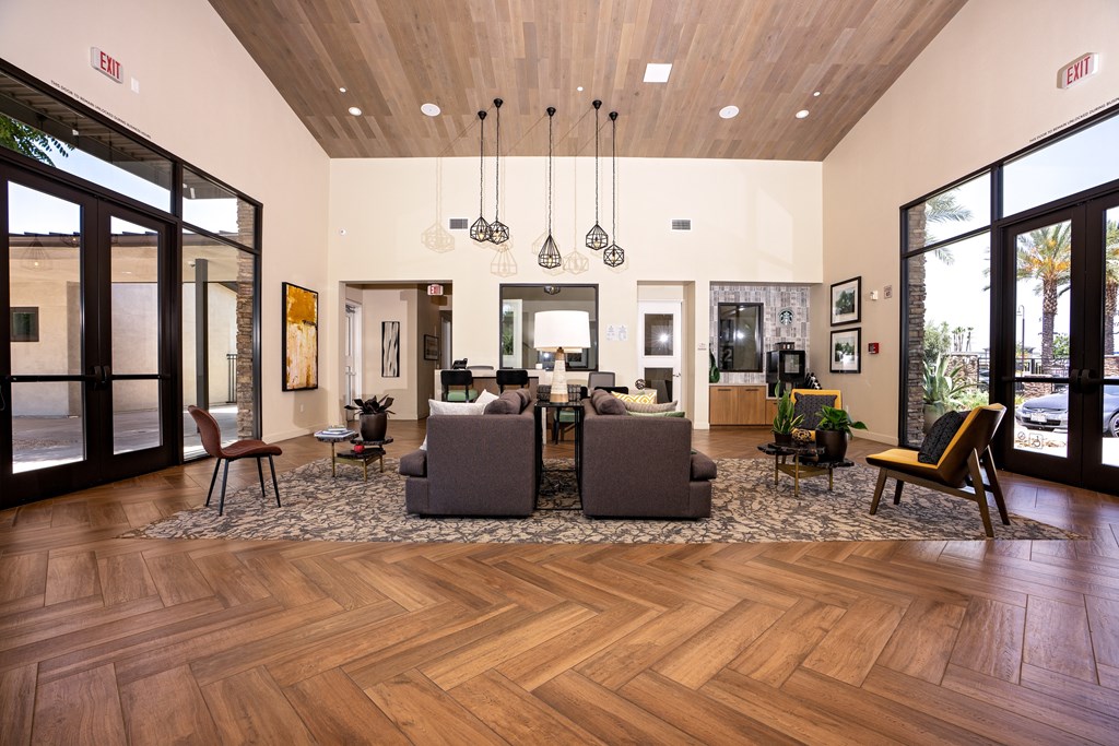 A living room with a wooden floor and a large couch.