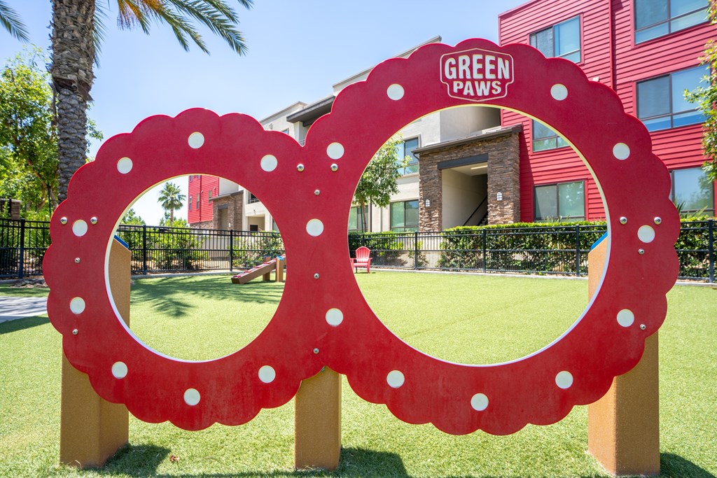 A red sign with white dots and the words "GREEN PAWS" in white letters.