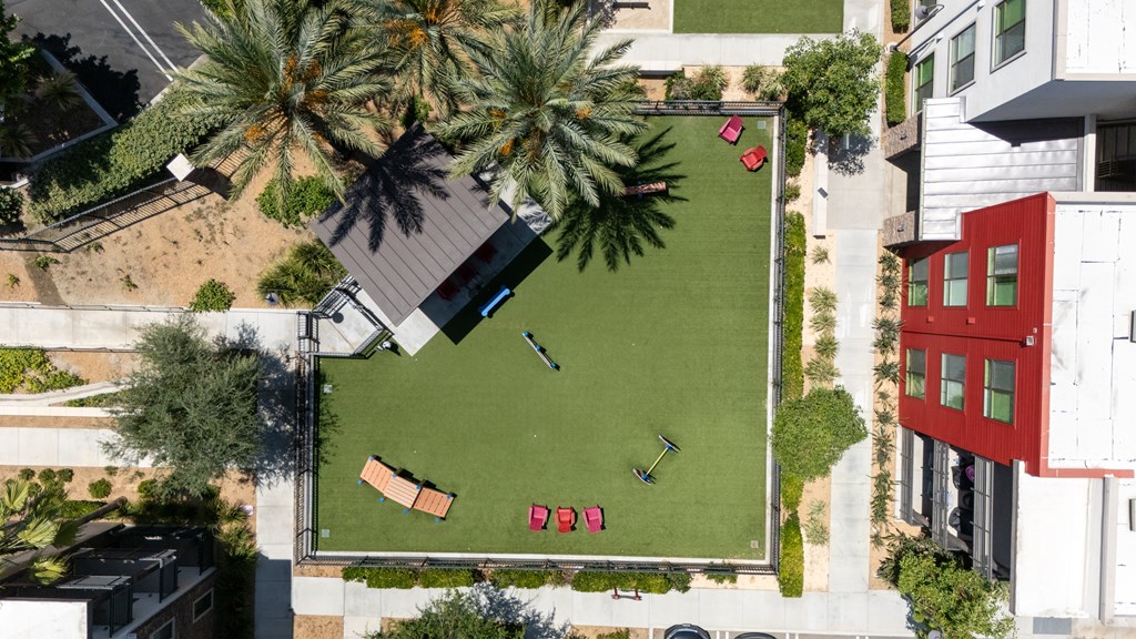 A red building is situated next to a green lawn with a sign that says "BED".