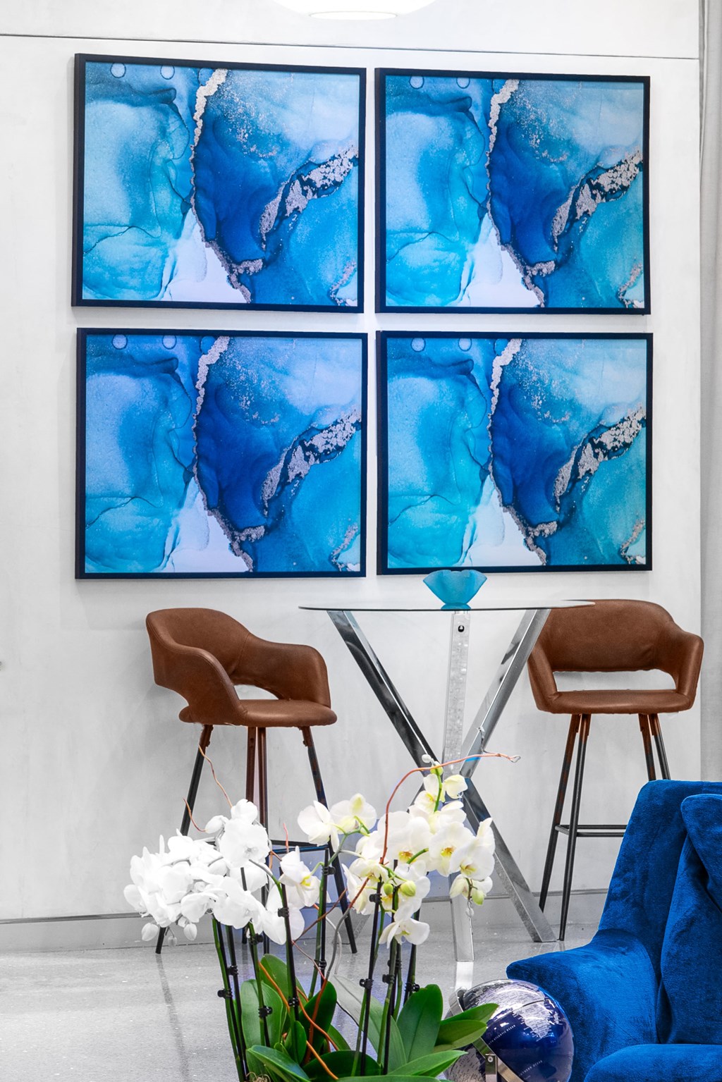 two chair and art on wall behind them.