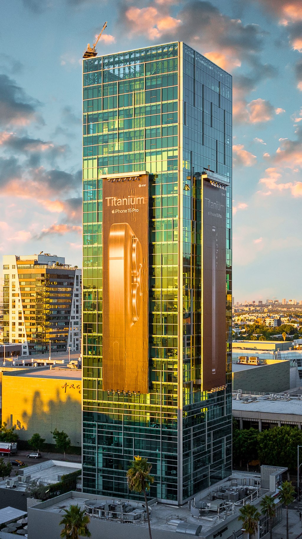 a tall building with two large ads on the side of it