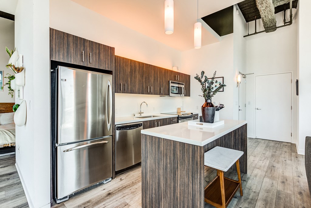 a kitchen with stainless steel appliances and wooden cabinets