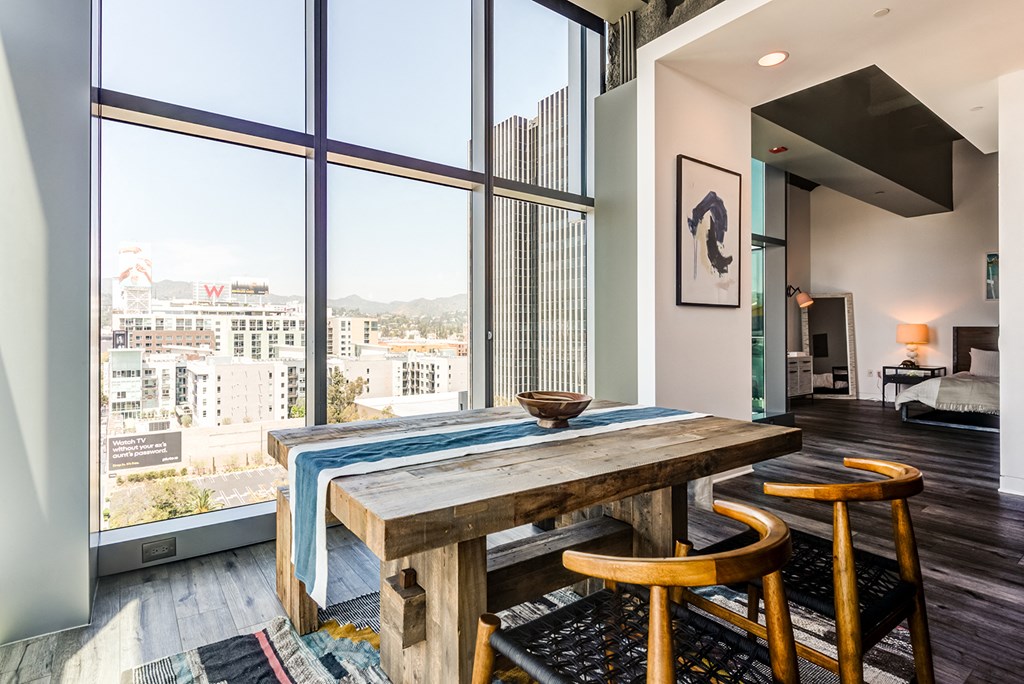 a dining room with a wooden table and wooden stools