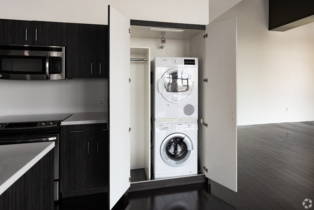 a washer and dryer hidden by a wall in a kitchen