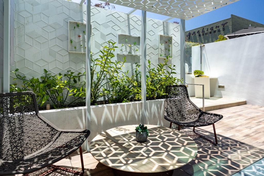 a terrace with two chairs and a table