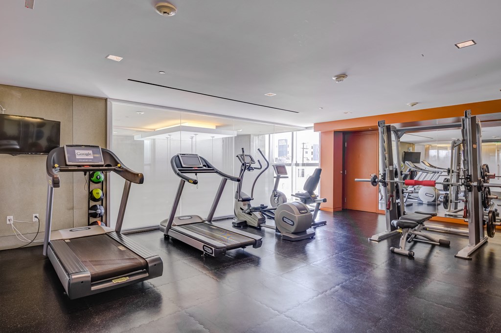 a gym with treadmills and other exercise equipment