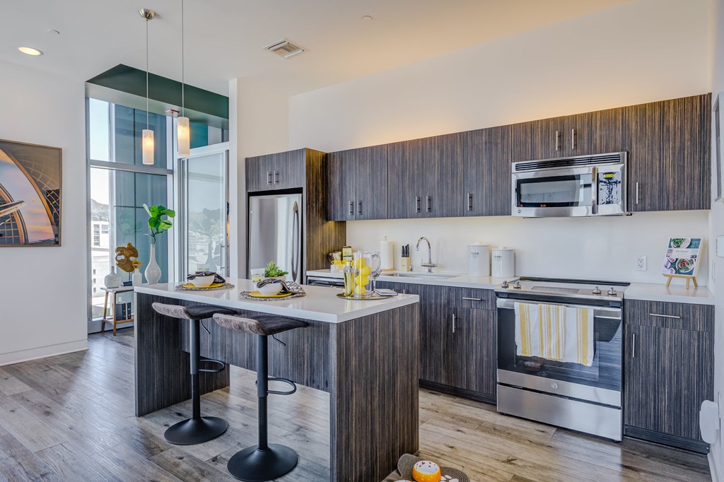 a kitchen with a large island with a breakfast bar