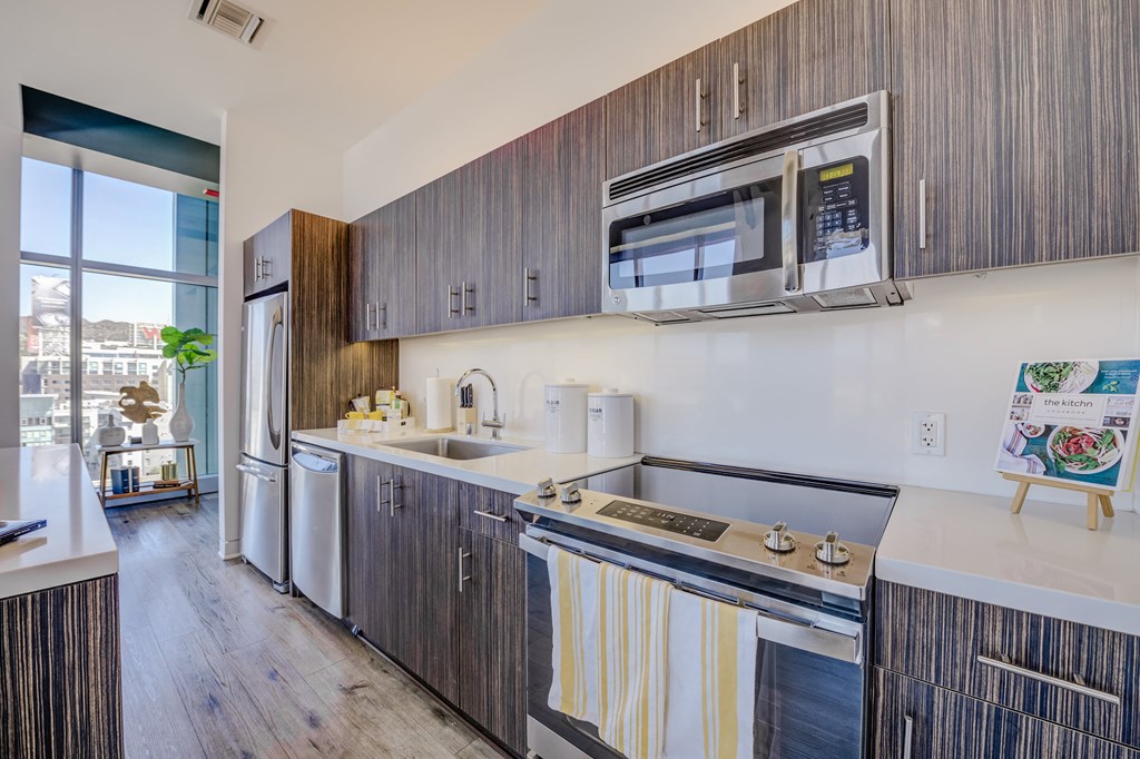 Hollywood, CA Apartments for Rent - Sunset Vine Tower - Kitchen Area with Long Kitchen Island, Stainless-Steel Appliances, and Cabinets